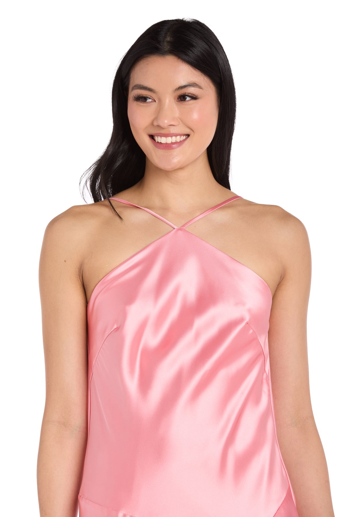 A woman with long dark hair smiles and looks to the side, wearing the Morgan 19102 knee-length satin party dress in pink with thin straps.